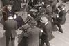 Marie Curie (circa 1915) with a group of cameramen on board a ship