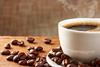 Coffee cup and coffee beans on table