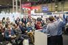 Group of people listening to a speaker give a presentation at a conference