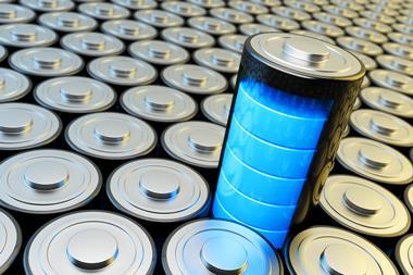 A battery stands above a columns of stacked batteries, displaying full power using five bright blue bars