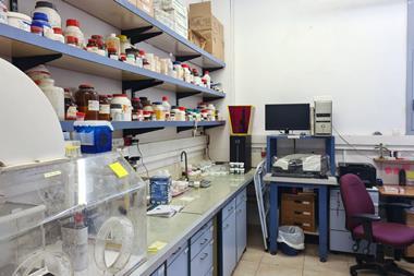 A chemistry lab with chemical bottles on shelves